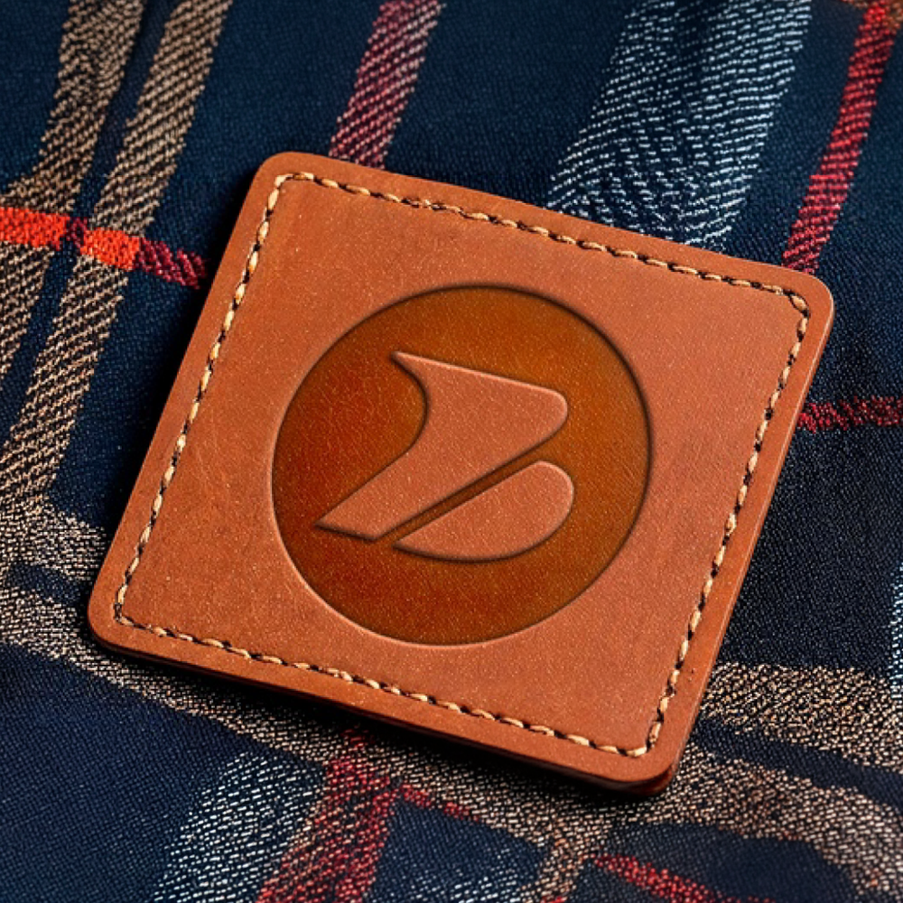 Faux-leather deboss patch on branded company apparel — a retail-style decoration for custom promotional caps and corporate jackets